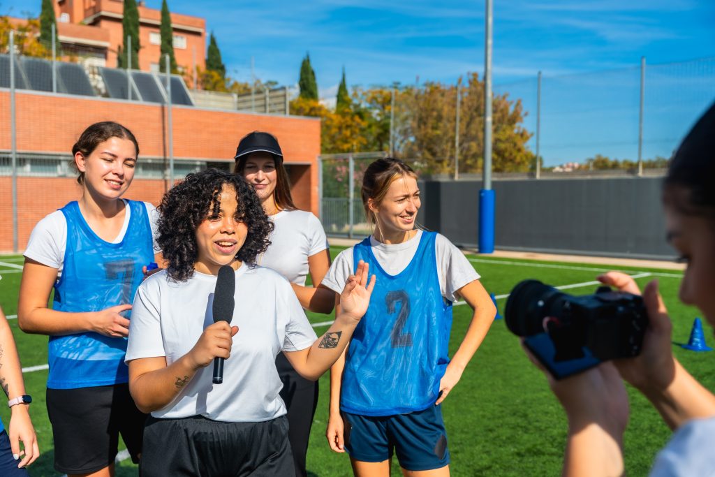 women's football team giving interview after game